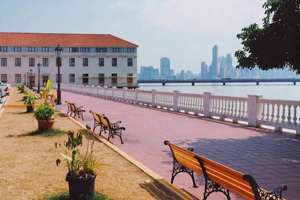 brick walkway on the water with benches