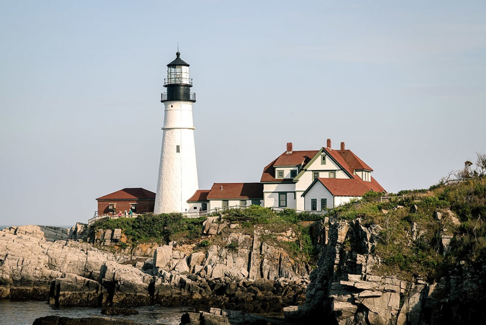 lighthouse on cliff during daytime