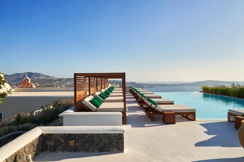 infinity pool and accompanying deck overlooking Greek Mediterranean