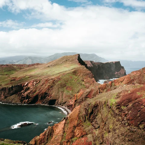 The rugged coast of Madeira against the Atlantic ocean. 