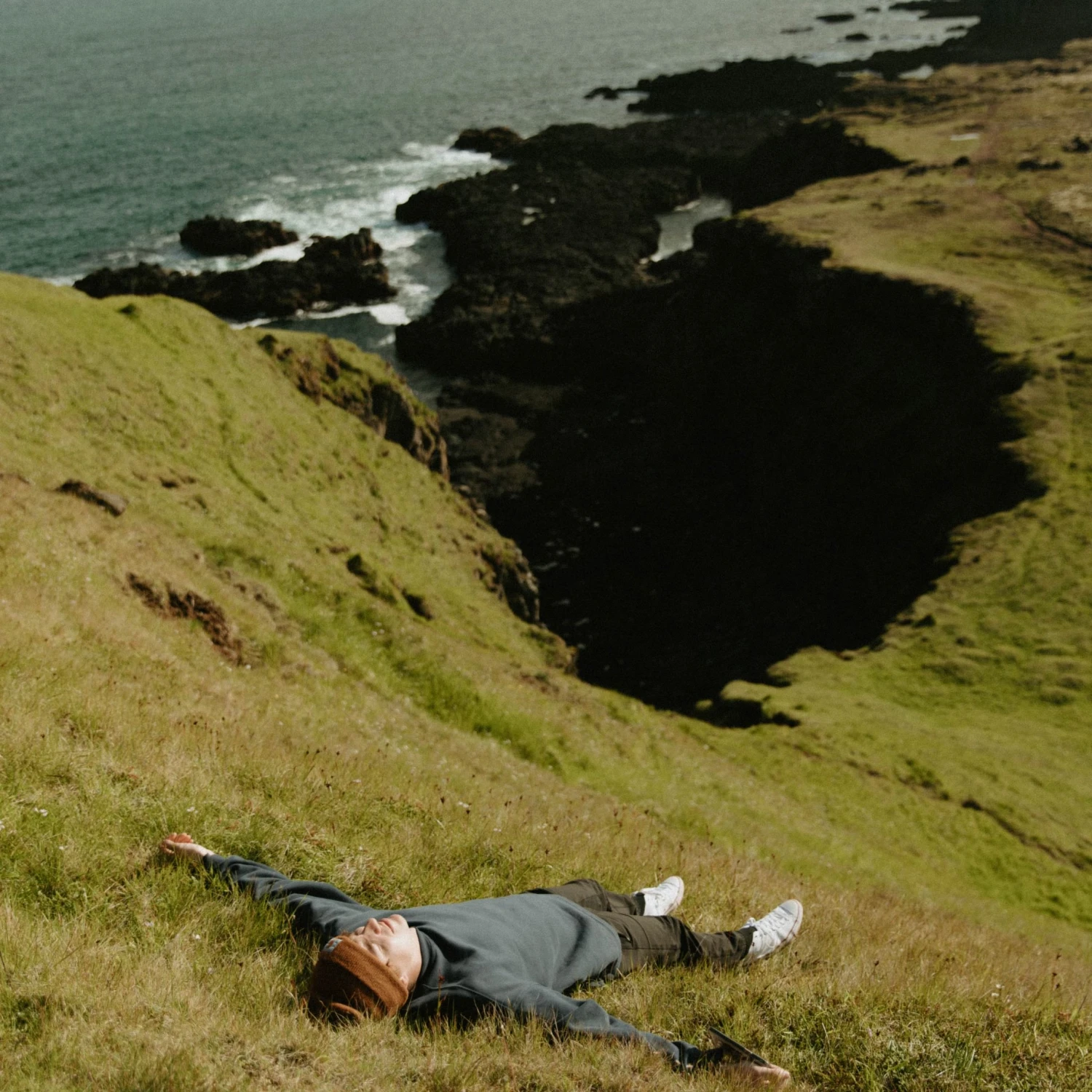 Travel advisor lying down on a beachside valley
