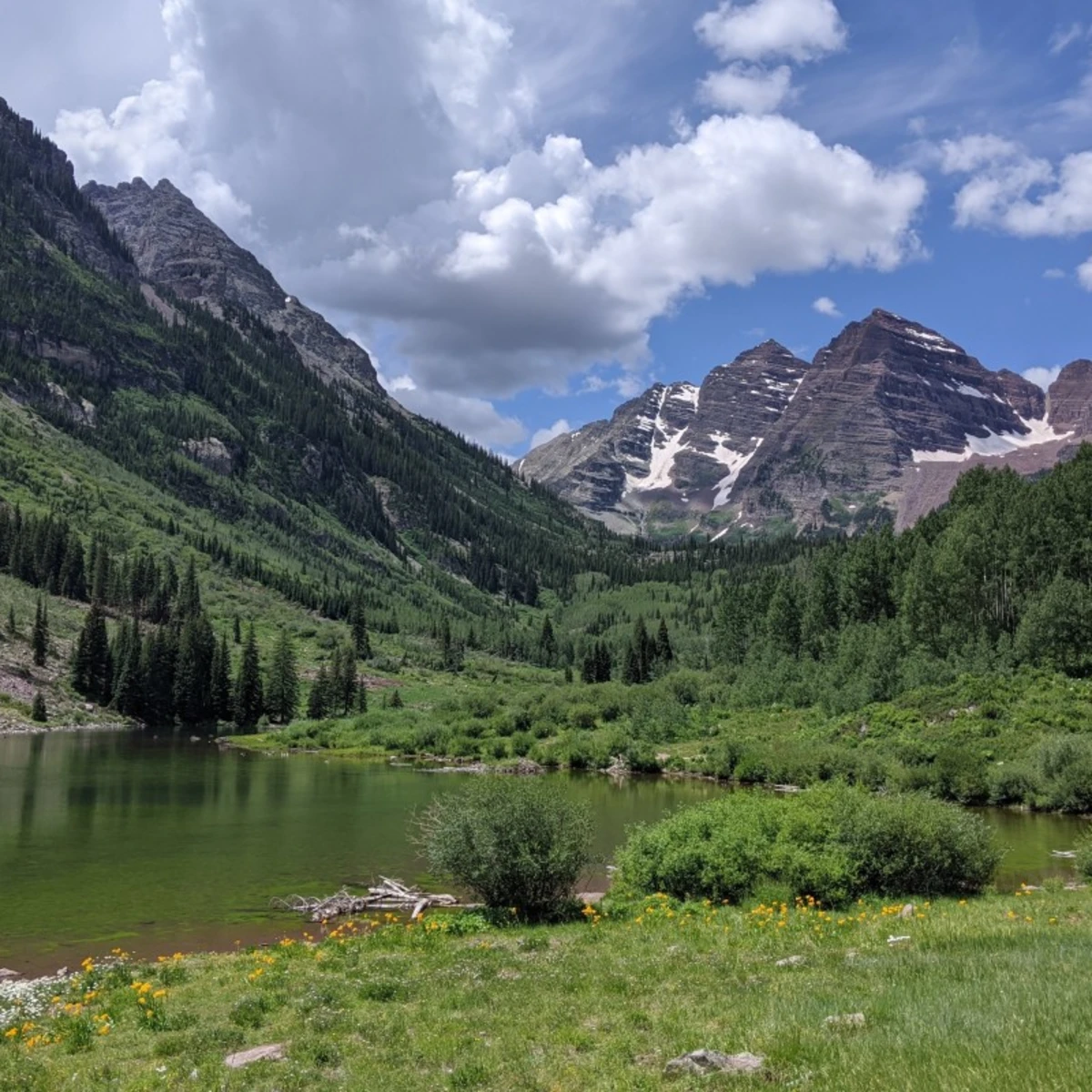 lake in an alpine valley amid a rocky peak