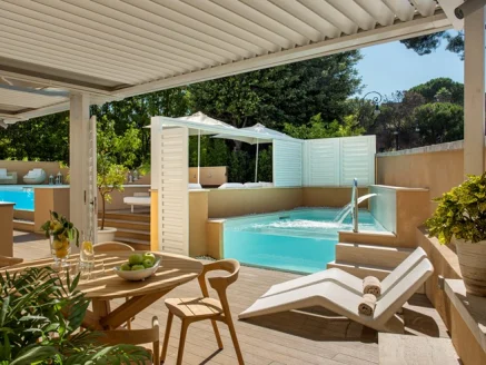 wooden pool deck with tables and chairs