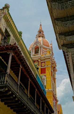 a view from the street below of ornate yellow, orange, red and white chapel 