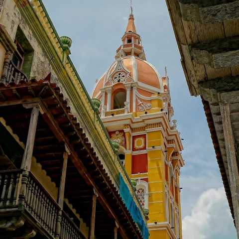 a view from the street below of ornate yellow, orange, red and white chapel 