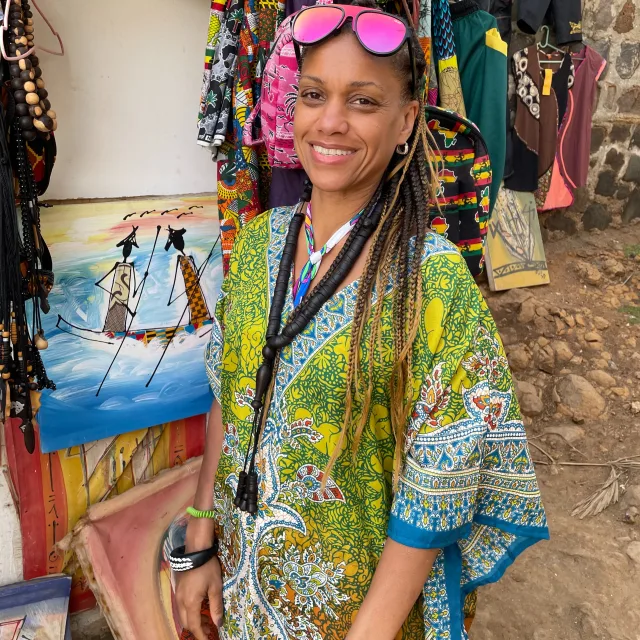Travel advisor LeShawn Anderson in a local craft shop wearing colorful dress.