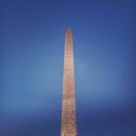 A sky touching building lighting up in Washington D.C.