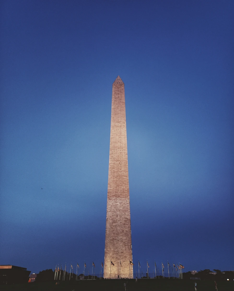 A sky touching building lighting up in Washington D.C.