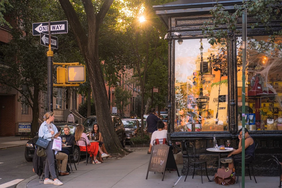 a cafe on the corner of a new york city street in the afternoon