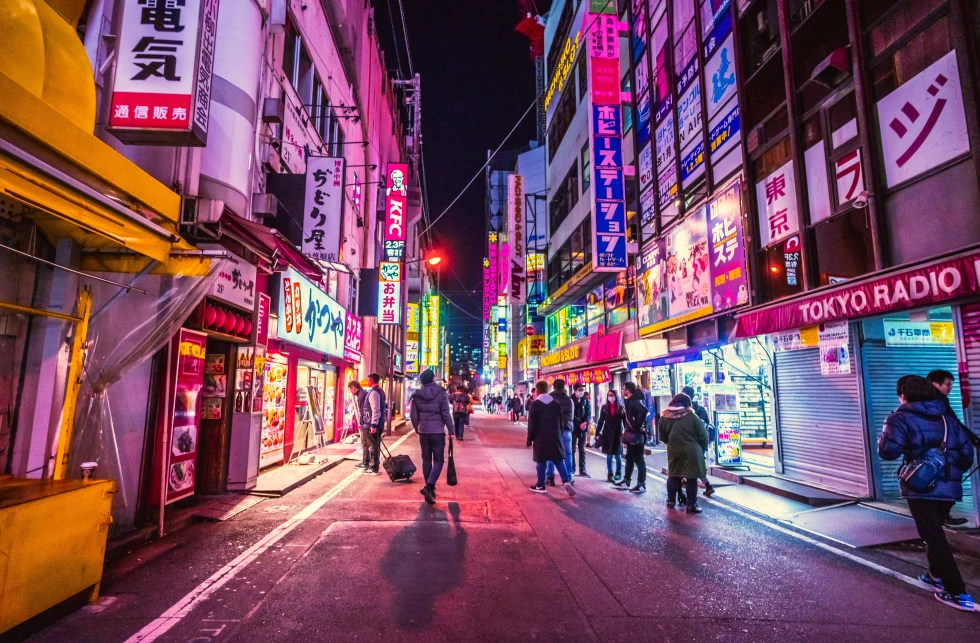 Busy downtown Japan, Tokyo featuring neon lights at night. 