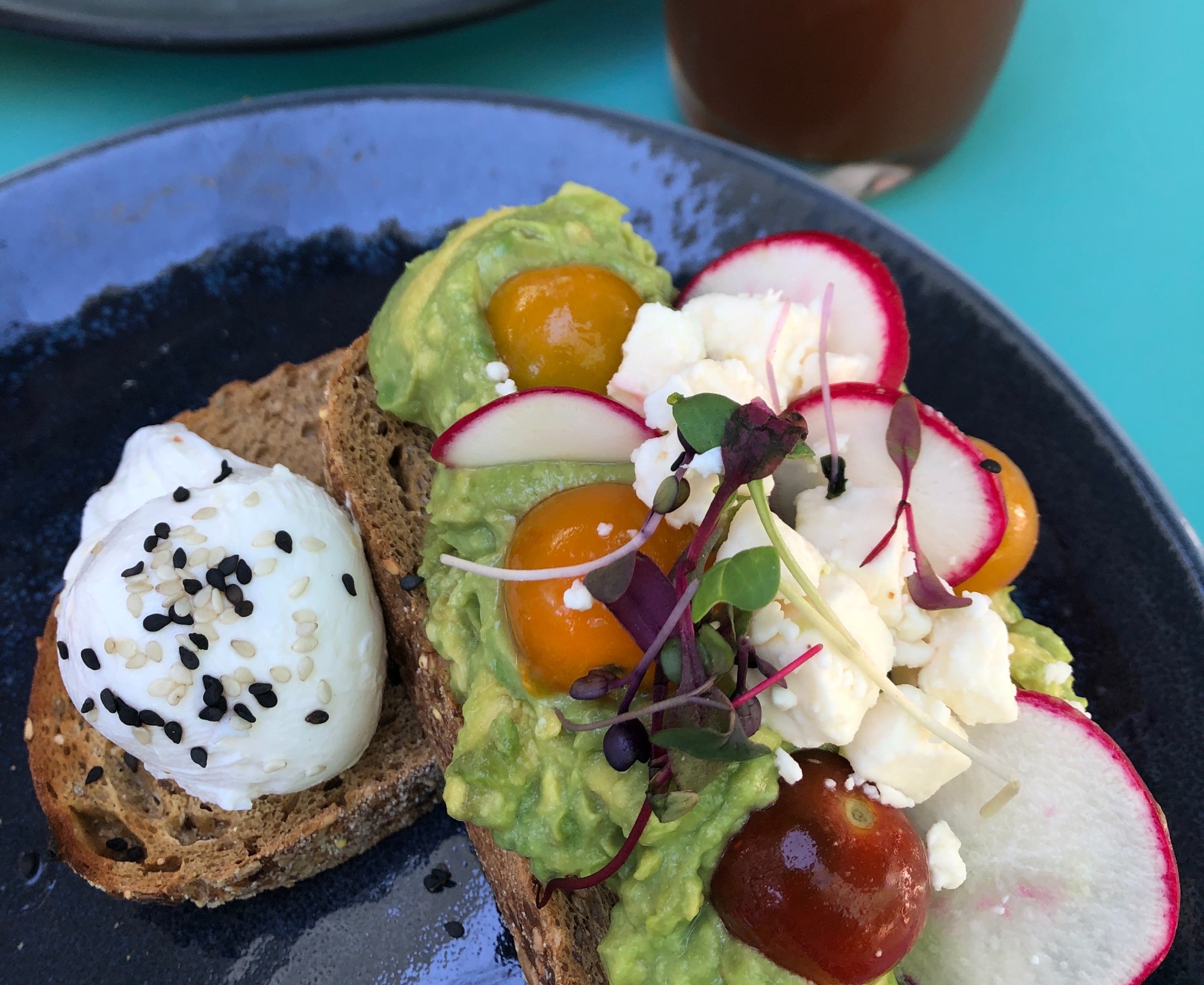 avocado toast with radish, tomatoes, egg and cheese