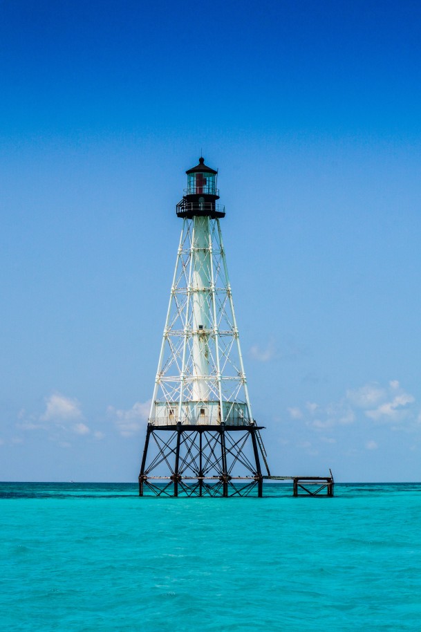 Lighthouse in bright blue waters on a sunny day in Islamorada