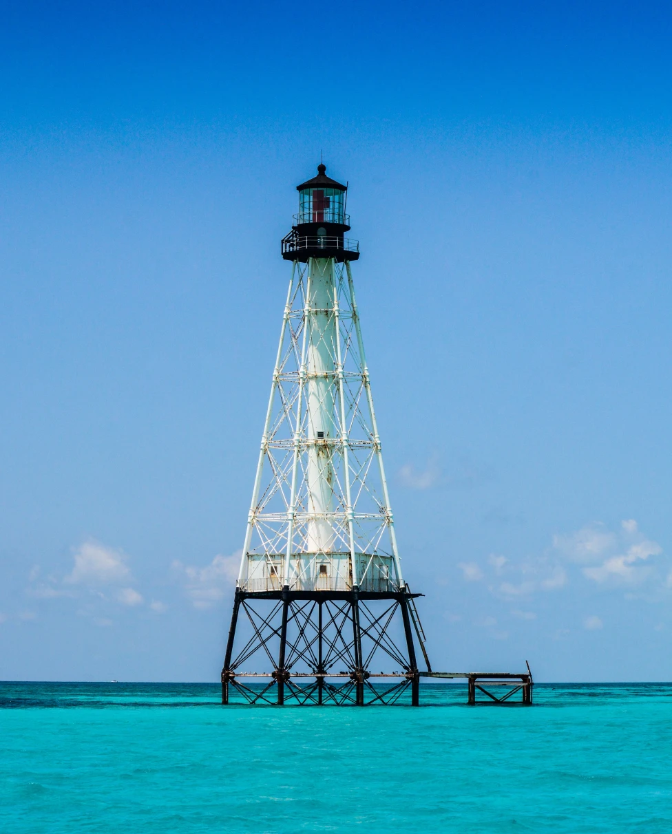 Lighthouse in bright blue waters on a sunny day in Islamorada