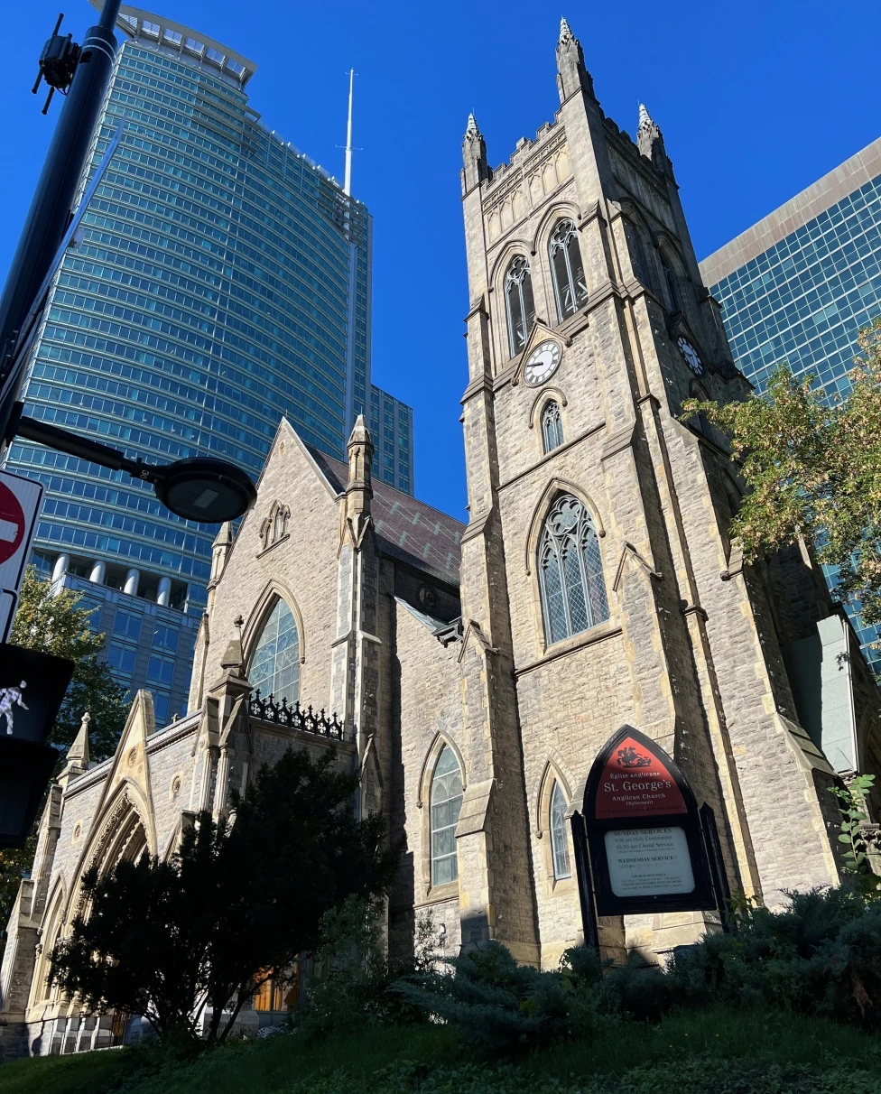 A bottom up view of a church and sky scraper in Montreal.