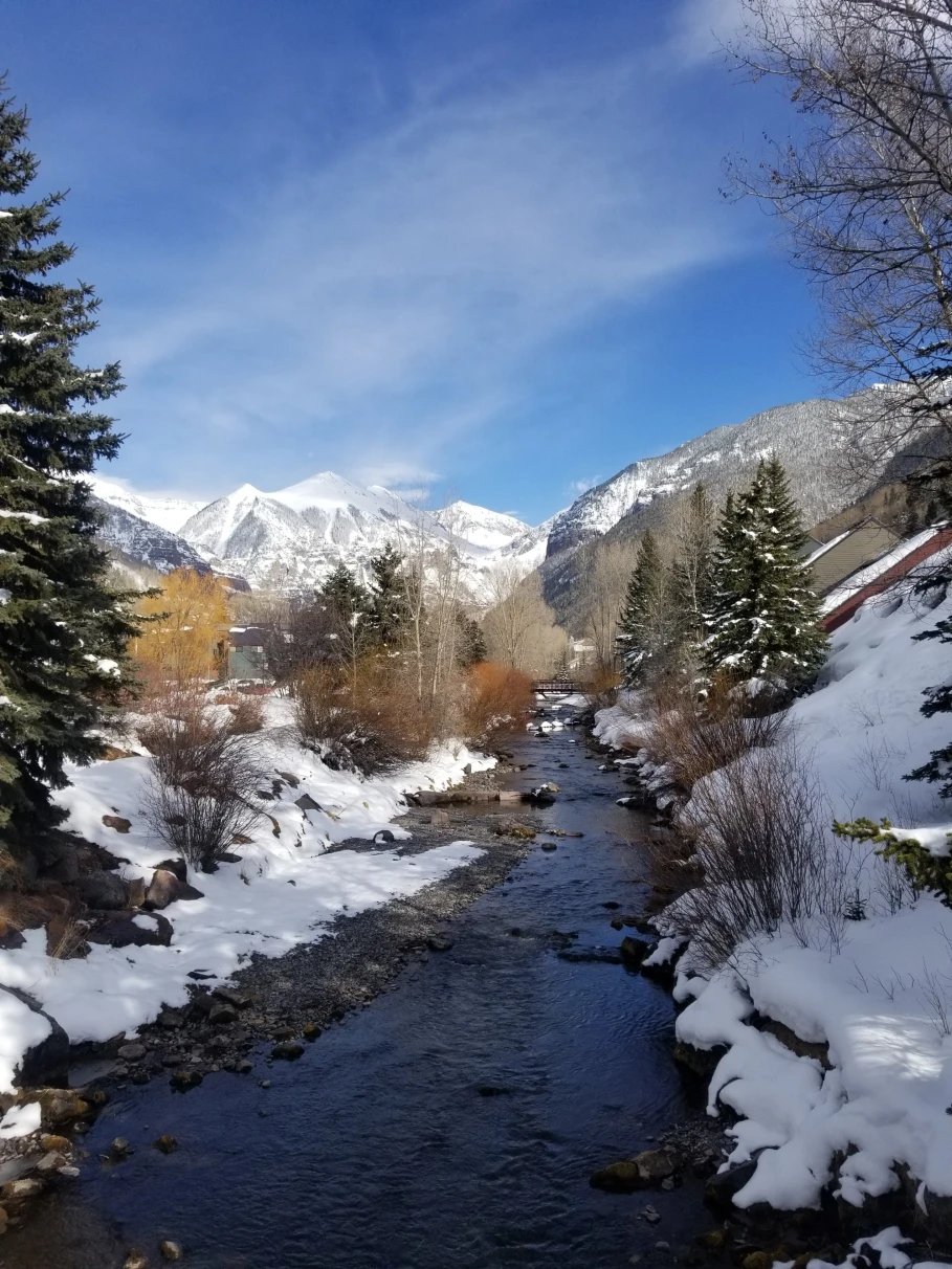 stream through snowy mountain range