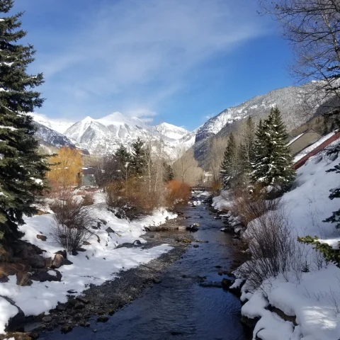 stream through snowy mountain range