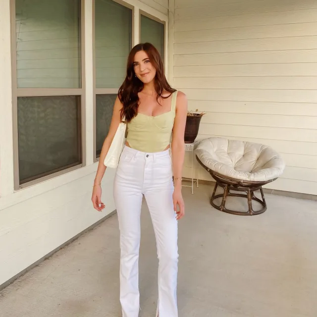 Travel advisor Francesca Rietti wearing skin colored top and white jeans, posing for the picture.