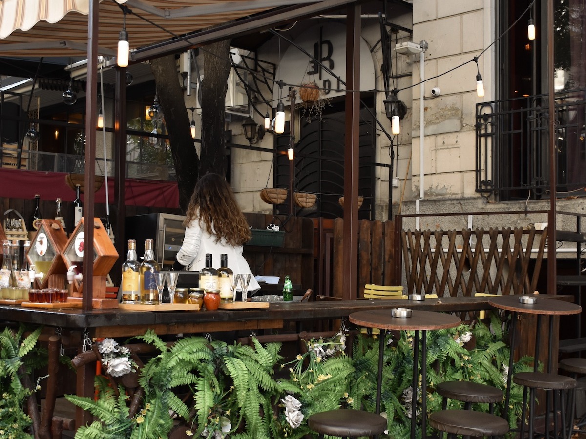 An outdoor seating area surrounded by potted plants
