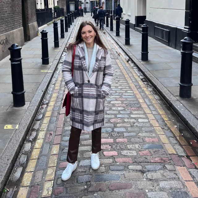 Travel Advisor Gina Rodi standing on a street weaing a black and white blazer 