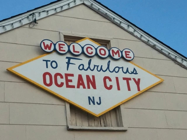 A sign that reads 'Welcome to Fabulous Ocean City NJ' on the top of an a-frame building. 