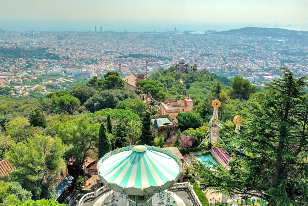 aerial view of a big city with an amusement park surrounded by trees