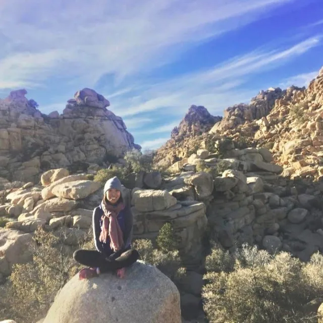 Travel advisor posing on a rock