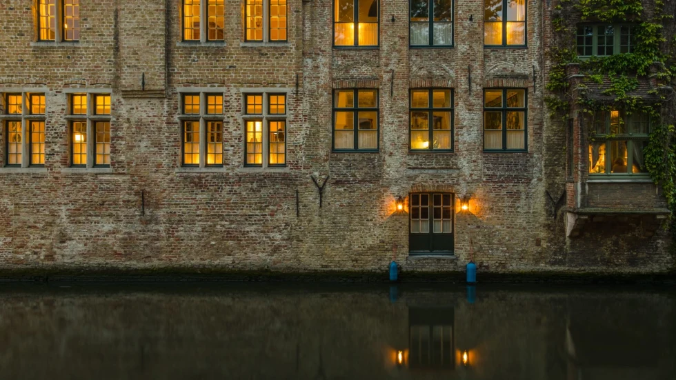 golden light through brick building on a canal