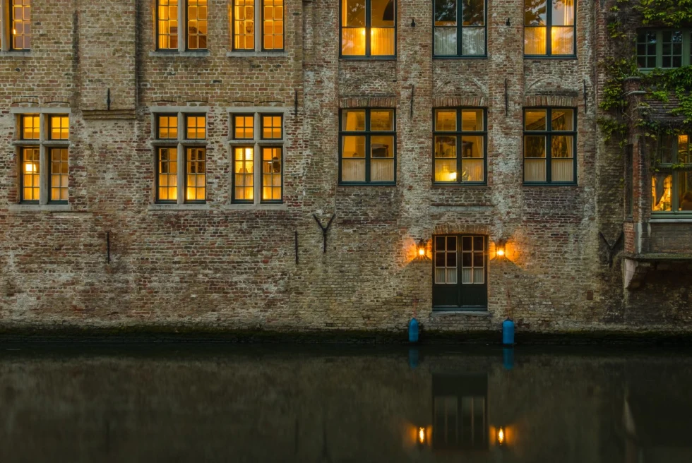 golden light through brick building on a canal