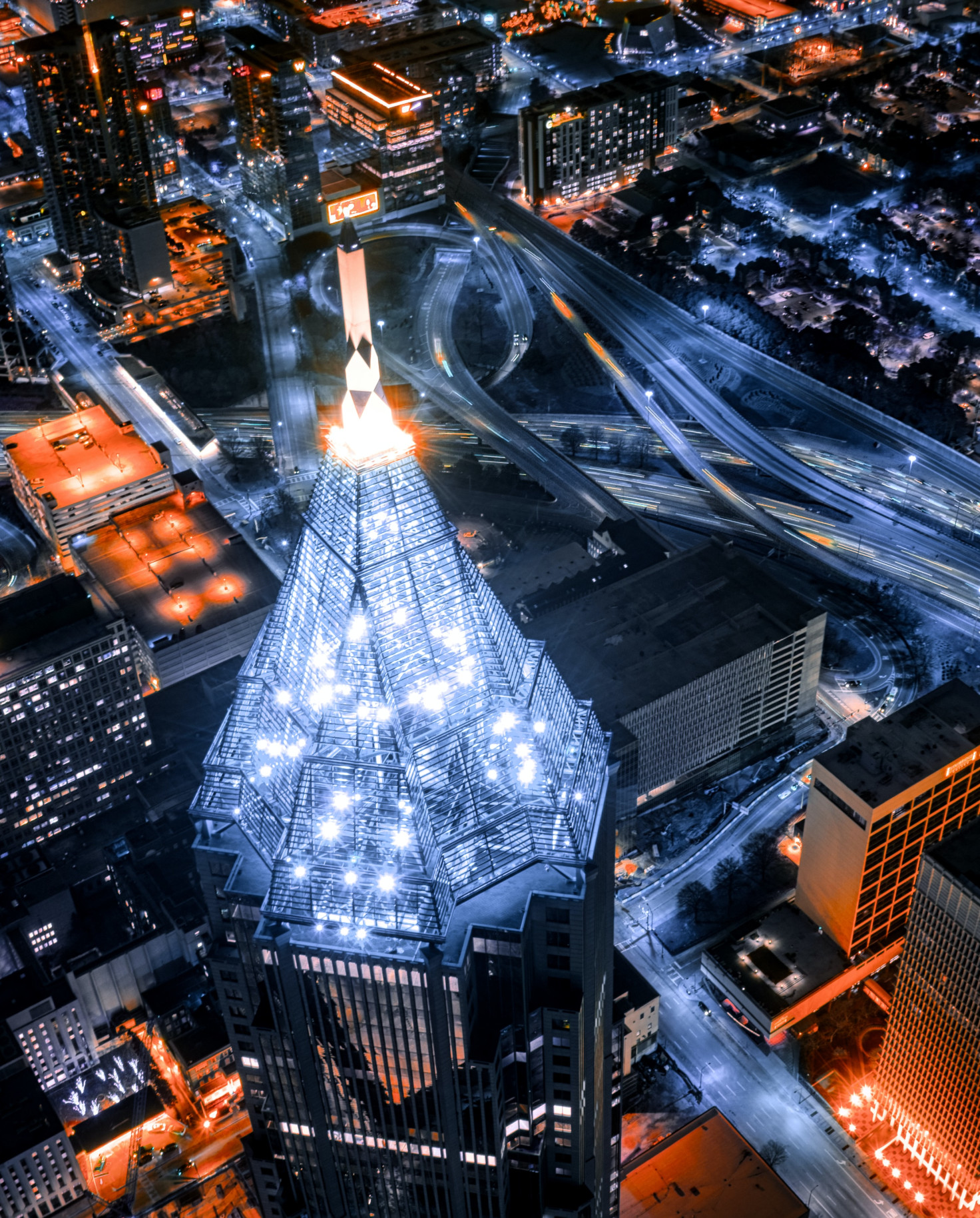 An aerial view of Atlanta, Georgia at night with red and white lights. 