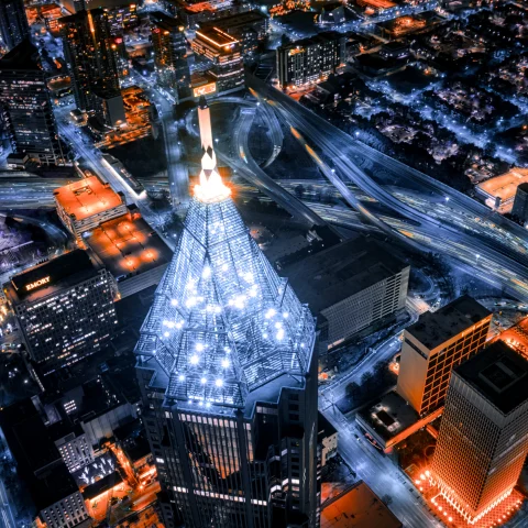 An aerial view of Atlanta, Georgia at night with red and white lights. 