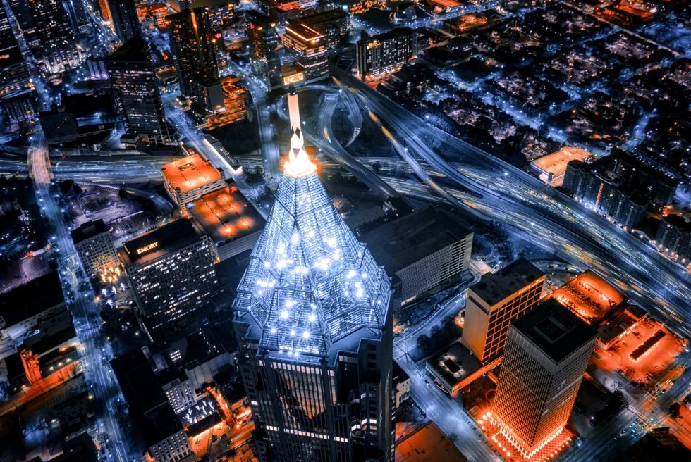 An aerial view of Atlanta, Georgia at night with red and white lights. 