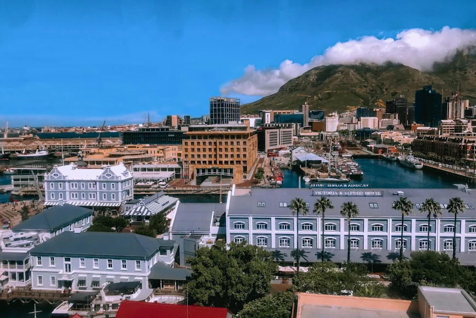 city on the water in the mountains on a clear blue sky day