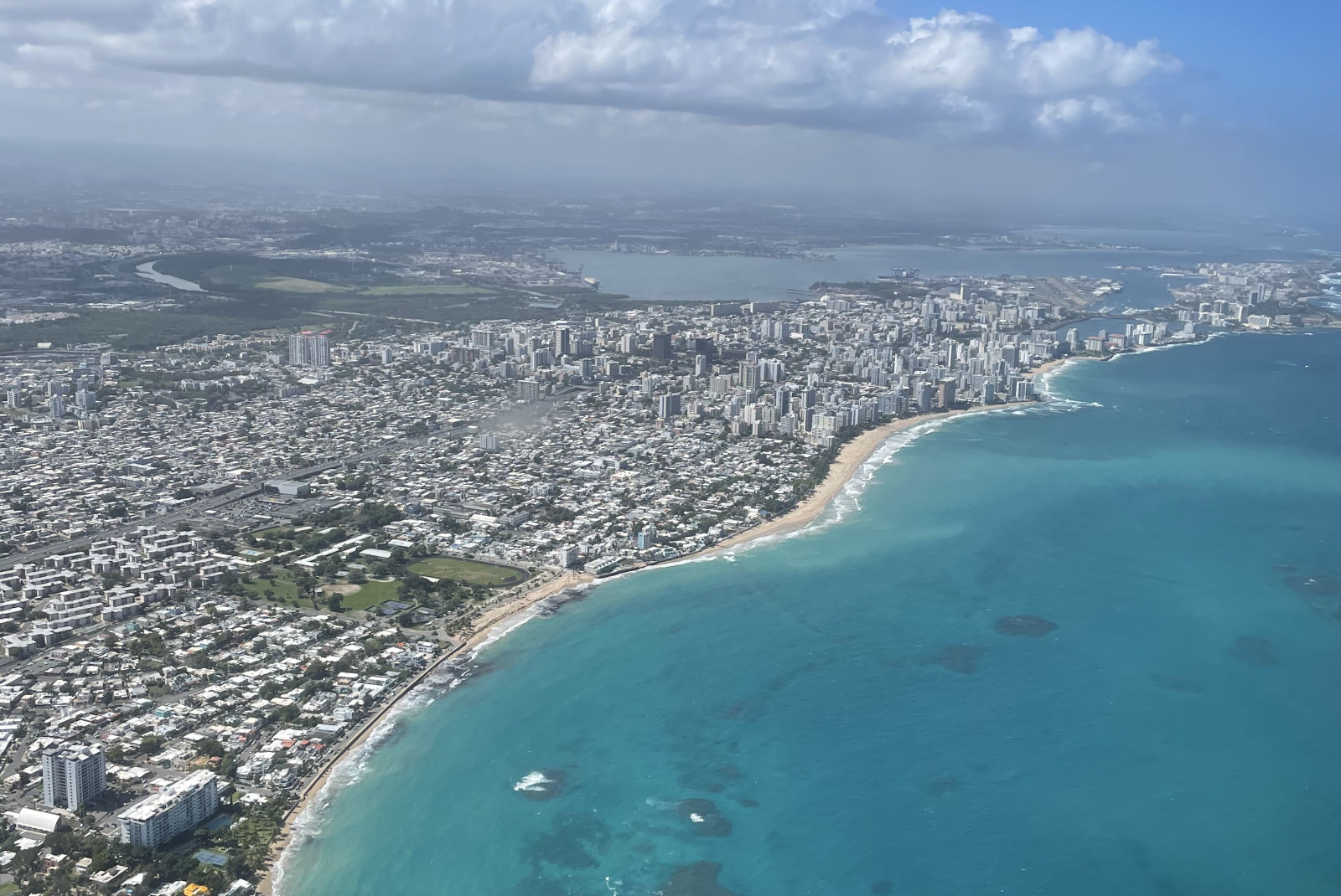 Aerial view of body of water and buildings on a sunny day during daytime