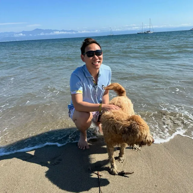 Travel Advisor Anson Tan with a white dog and tux. 