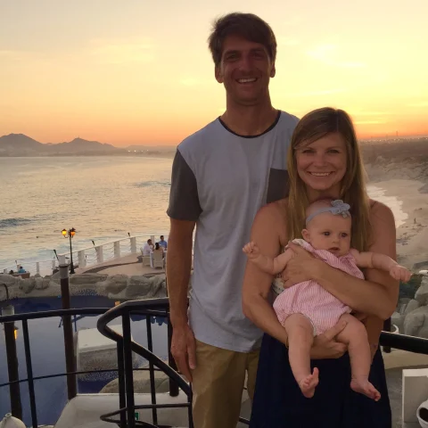 Travel advisor Jena Krinock with partner and baby at Sunset Monalisa restaurant overlooking the ocean at sunset