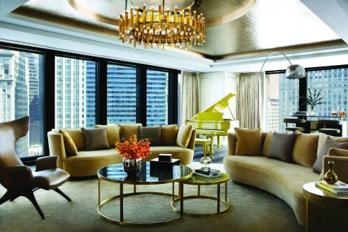 fancy penthouse with a yellow piano and rounded couches