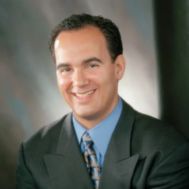 Travel advisor Aaron Wheeler in a professional portrait wearing a suit.