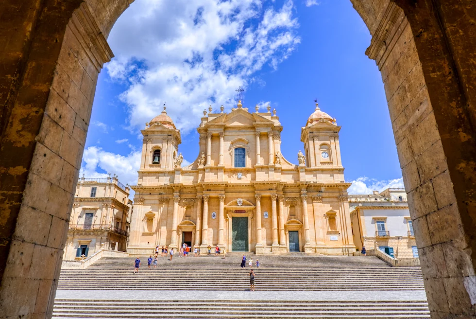 large white stately building next to stairs during daytime