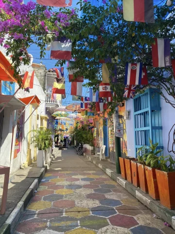A colorful street with hanging flags. 