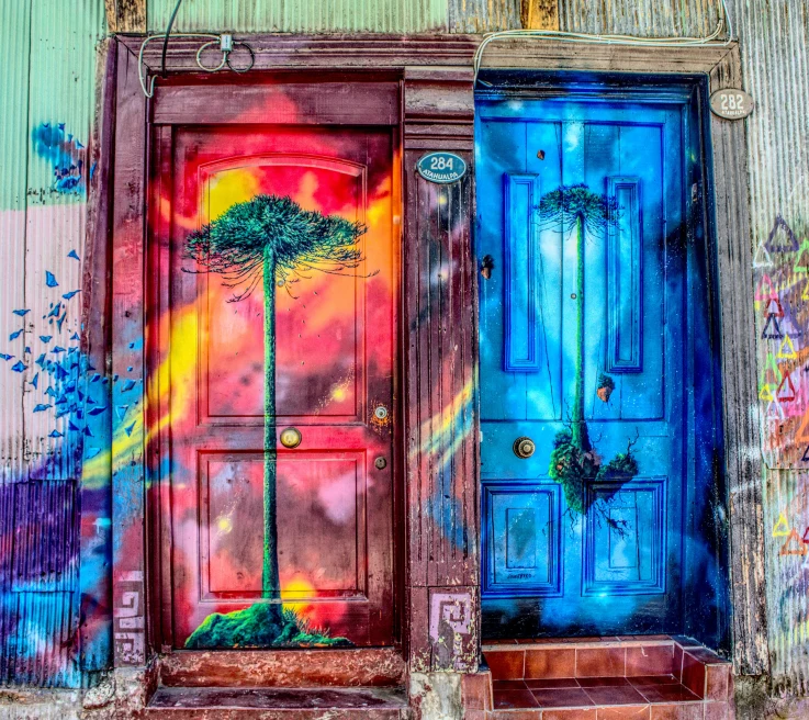 Two wooden doors painted pink and blue