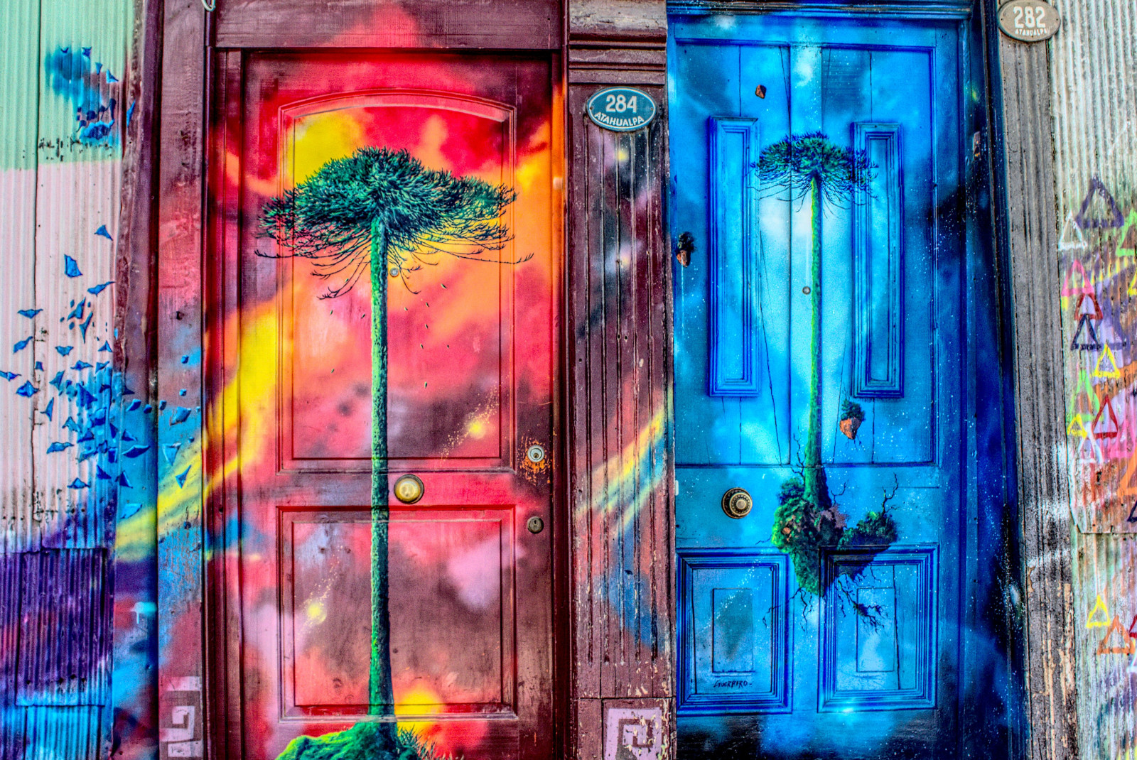 Two wooden doors painted pink and blue