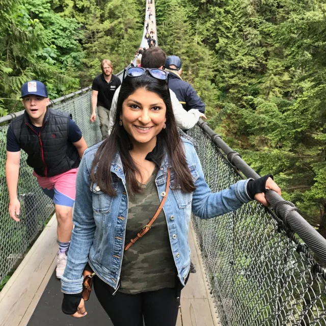 Travel Advisor Anahita Davis on a narrow bridge in a denim jacket. 