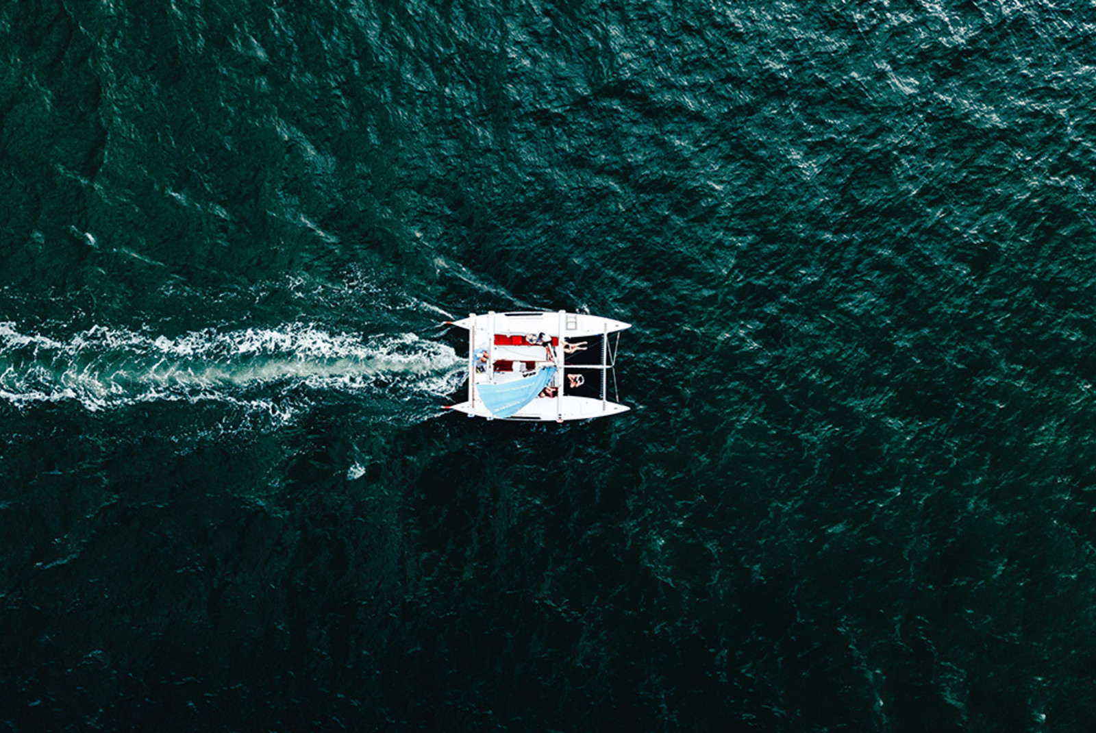 Aerial view of a white sailboat in the ocean in Las Catalinas Costa Rica 