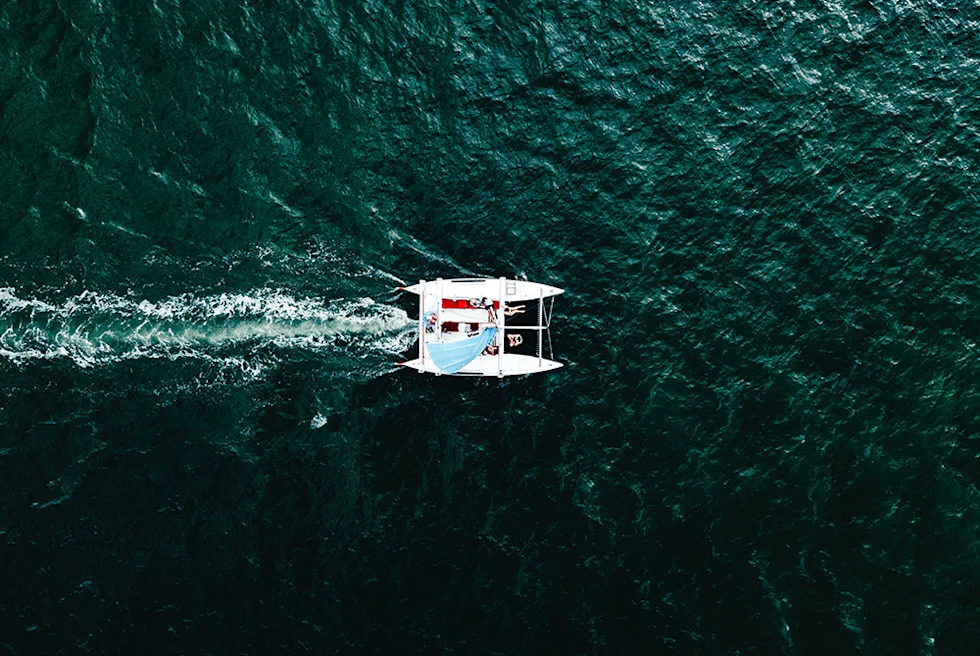 Aerial view of a white sailboat in the ocean in Las Catalinas Costa Rica