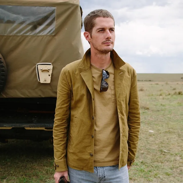 Scott standing in a field in front of a safari van