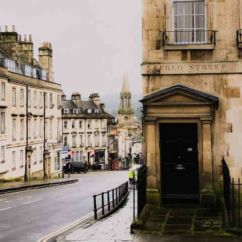 street lined with stone buildings with gray skies