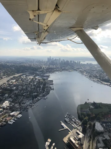 view of a city on the water from inside a seaplane