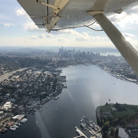 view of a city on the water from inside a seaplane