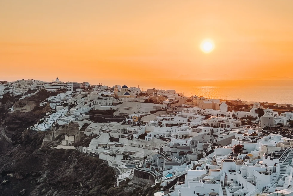 View of sunset over the roofs in Santorini.