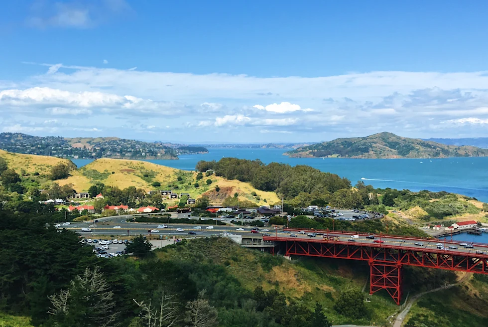 red bridge next to the ocean during daytime